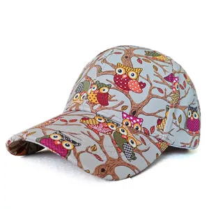 Close-up of gray baseball cap with colorful cartoon owl prints and cotton fabric texture