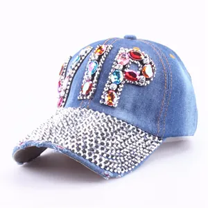 Close-up of colorful rhinestone VIP lettering and silver diamonds on denim baseball cap
