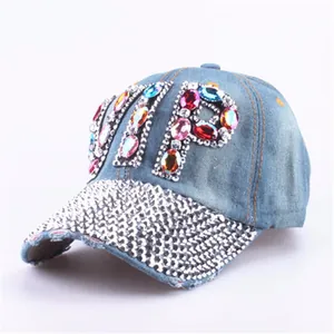 Detailed close-up of blue denim baseball cap with VIP rhinestones and crystal brim