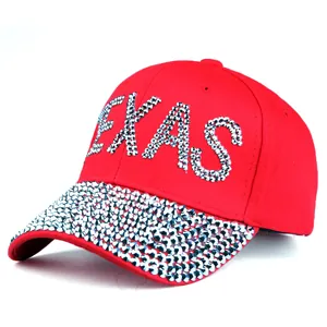 Detailed view of red baseball cap with silver TEXAS rhinestones on brim and front