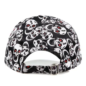 Black baseball cap with skull print and red glitter accents in a bird's eye view