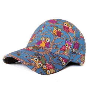 Detail of adult baseball cap with colorful cartoon owl print and navy cotton fabric