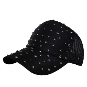 Detailed view of black trucker hat with silver rhinestone studs and breathable mesh