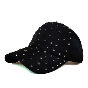 Detail of black baseball cap featuring silver metallic rivets and breathable fabric texture