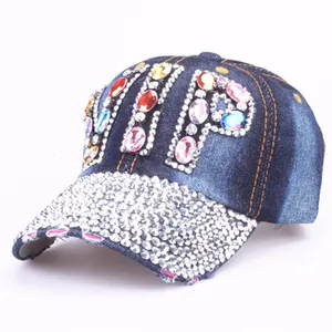 Detailed view of VIP logo made of colorful rhinestones on blue denim baseball cap