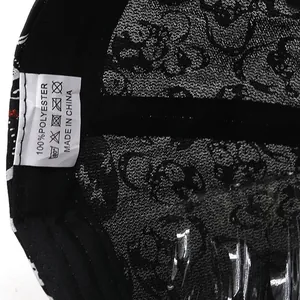 Detail of 100% polyester baseball cap lining with skull print and care label