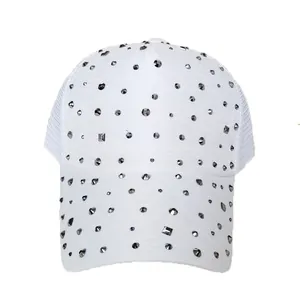 Close-up of white mesh baseball cap featuring decorative silver rhinestones and studs