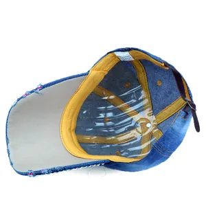 Detail view of denim baseball cap interior with cotton label and vintage distressed edges