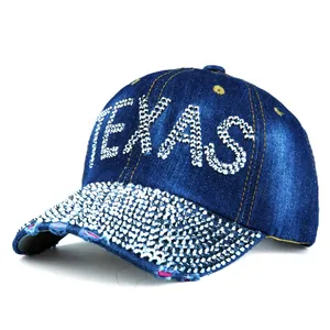 Detailed view of the sparkling rhinestone TEXAS lettering and frayed denim cap brim