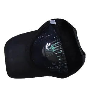 Detail of black cotton baseball cap interior with wash label and adjustable back strap
