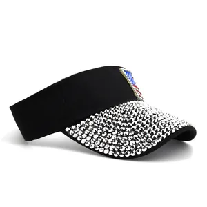 Detail of sparkling silver rhinestones and shield patch on black sun visor hat
