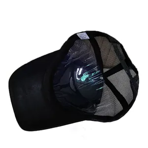 Detail of baseball cap interior showing mesh back, cotton fabric, and adjustable strap