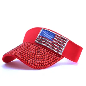 Detail of red rhinestone sun visor with sparkling American flag patch on the front