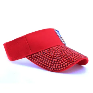 Close-up of sparkling red rhinestones and American flag patch on a red sun visor