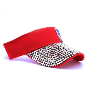 Red sun visor hat for women featuring sparkly rhinestones and American flag patch details