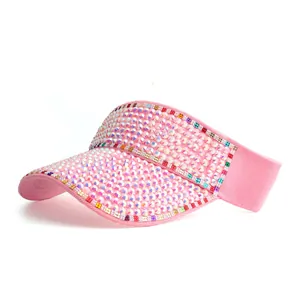Detailed close-up of pink sun visor hat with sparkling colorful rhinestones and crystal trim