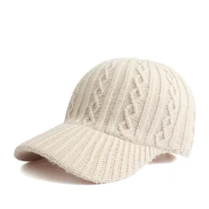 Detailed cable-knit texture on minimalist cream winter baseball cap for women