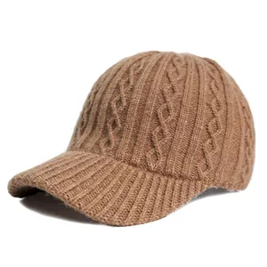 Macro shot of cable knit texture and ribbed brim on a camel winter baseball cap