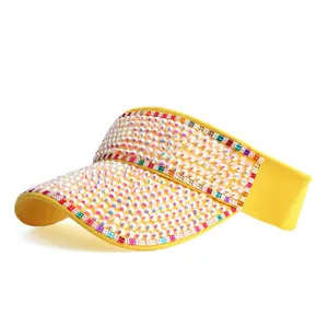 Detailed view of colorful rhinestones on a bright yellow sun visor hat's brim