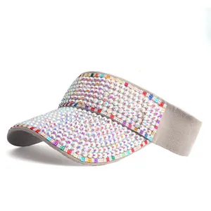 Detailed view of rhinestone sun visor with colorful crystals on dark grey fabric