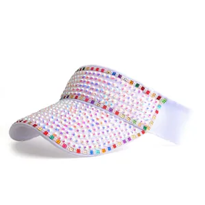 Macro detail of white sun visor hat featuring colorful rhinestones and sparkling gems