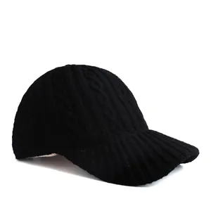 Women's black knitted baseball cap featuring classic cable weave and warm winter fabric