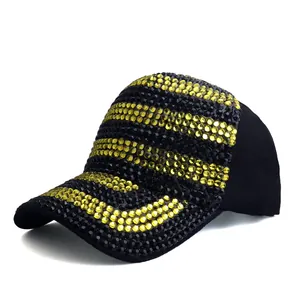 Detail of a baseball cap with yellow and black rhinestones in a striped pattern