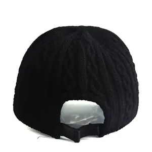 Women's black cable knit baseball cap featuring an adjustable back strap for a warm fit
