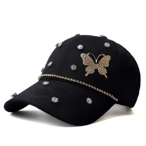 Detailed view of black baseball cap with rhinestone butterfly and jacquard floral pattern