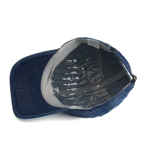 Internal structure of washed denim baseball cap with grey sweatband and white label