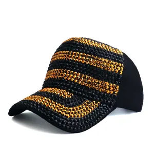 Close-up of dual-tone black and gold striped baseball cap with full rhinestone embellishment