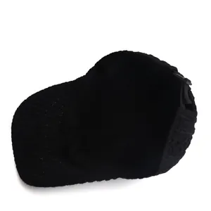 Detail view of the black knitted baseball cap interior lining and adjustable back strap