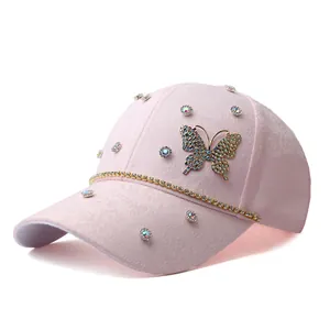 Close-up of pink baseball cap featuring a large 3D butterfly with sparkling colorful rhinestones