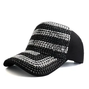 Close-up of black baseball cap featuring stripes of sparkling silver and black rhinestones