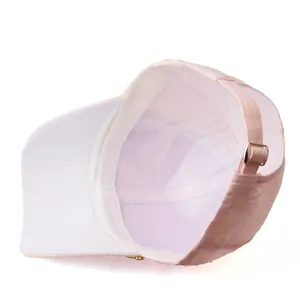 Detail view of pink baseball cap with adjustable metal buckle and textured fabric