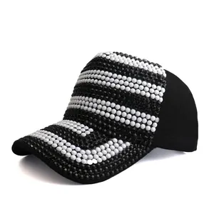 Detail shot of a black baseball cap with intricate two-tone rhinestone stripe patterns
