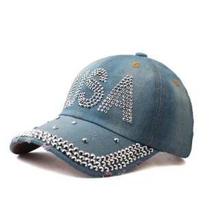 Detail view of light blue denim cap with USA silver rivets and distressed brim edges