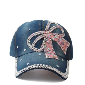 Denim baseball cap for women with pink floral bow and sparkling rhinestone accents