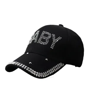 Fashionable black baseball cap featuring silver rhinestone BABY letters and studded brim