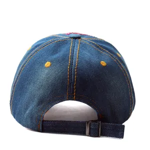 Rear view of blue denim baseball cap with orange stitching and adjustable metal buckle