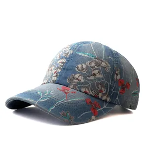 Detail view of ethnic floral print on blue denim baseball cap with curved brim