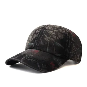 Detailed view of black denim baseball cap with vintage floral print and fabric texture