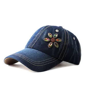 Close-up of denim baseball cap featuring colorful rhinestone flower and contrast stitching