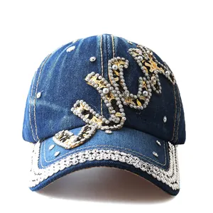 Close-up of denim baseball cap featuring leopard print Love letters with rhinestones