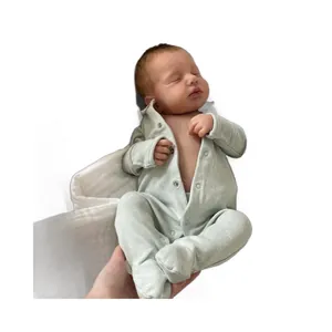 Realistic 49cm Loulou reborn doll in a light green long-sleeved star print romper