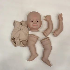Flat lay of a 24-inch reborn doll kit including vinyl limbs, head, and cloth body
