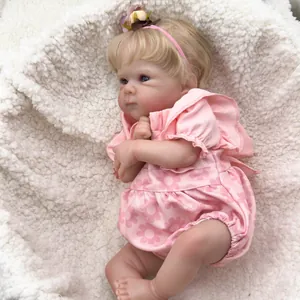 Close-up of 18 inch Bettie reborn doll with blonde hair and pink floral outfit