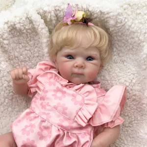 Realistic 18-inch reborn baby doll Bettie with curly blonde hair and floral pink dress