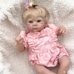 Realistic 18-inch reborn baby doll Bettie with blue eyes and floral outfit on a rug
