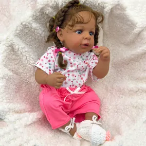 Detailed close-up of 19-inch lifelike reborn baby doll with curly hair and blue eyes